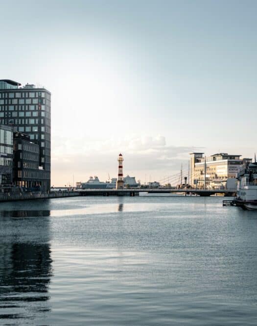 Photo by Karl Hörnfeldt white boat on water near city buildings during daytime